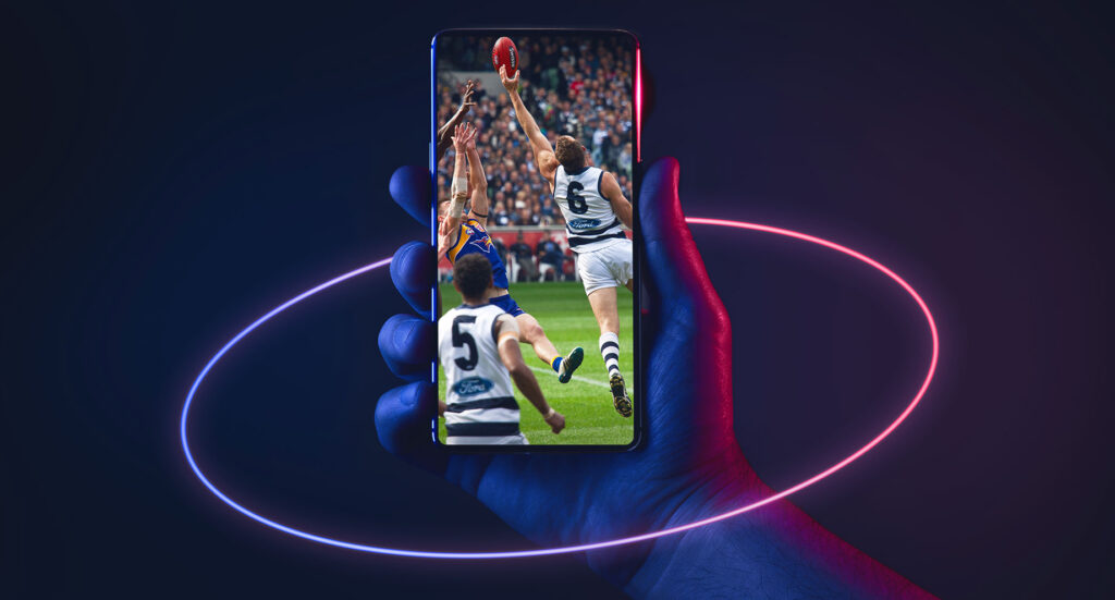 Hand holding phone displaying AFL games