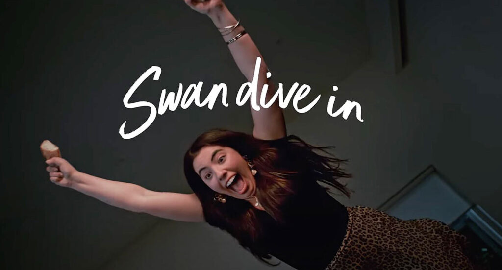 Swan dive in woman diving