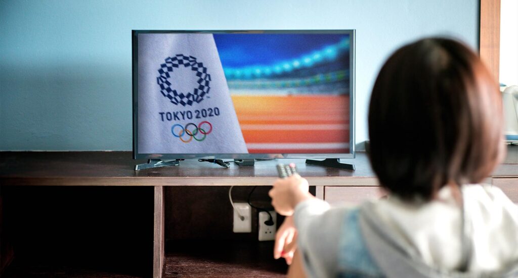 Woman watching TV with the Tokyo 2020 Olympic games