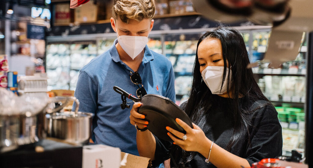 Couple shopping in store with hygiene masks on
