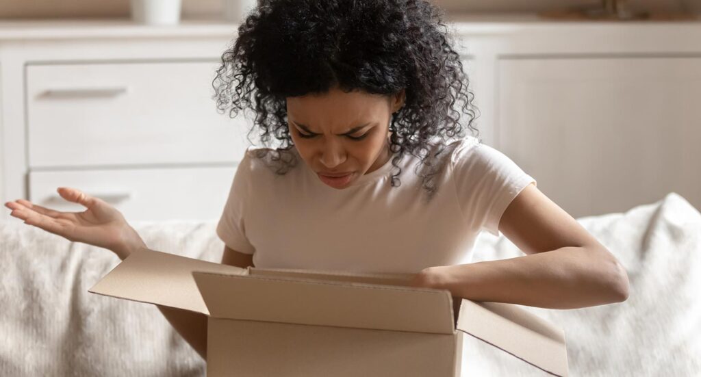 Confused woman looking into card box
