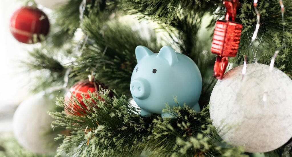 Piggy bank hanging on Christmas tree