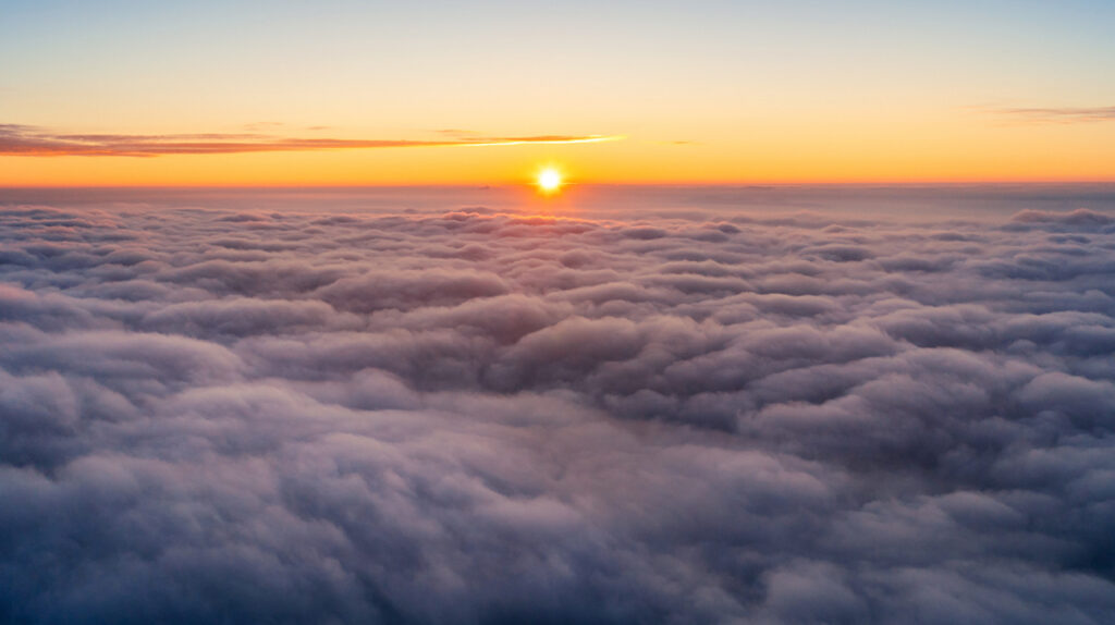 Panoramic view of sun over turbulent clouds